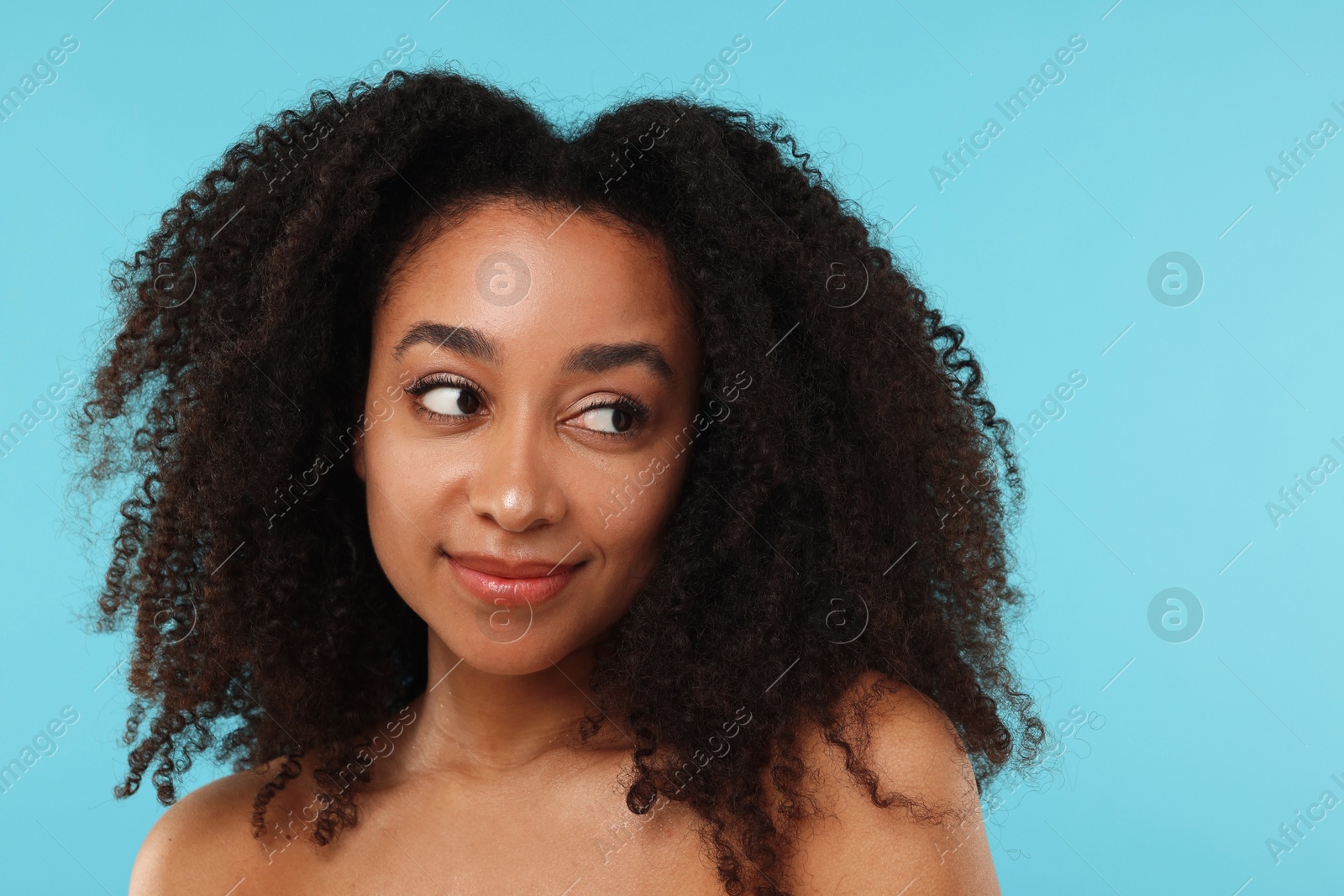 Portrait of beautiful Brazilian woman after spa treatment on light blue background Photo of Portrait of beautiful Brazilian woman after spa treatment on light blue background
