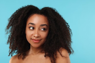 Photo of Portrait of beautiful Brazilian woman after spa treatment on light blue background