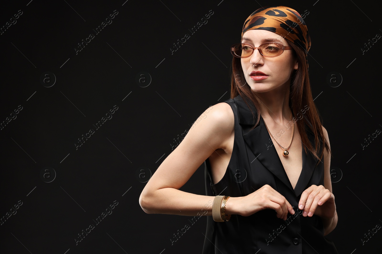 Portrait of beautiful woman in stylish outfit on black background, space for text Photo of Portrait of beautiful woman in stylish outfit on black background, space for text