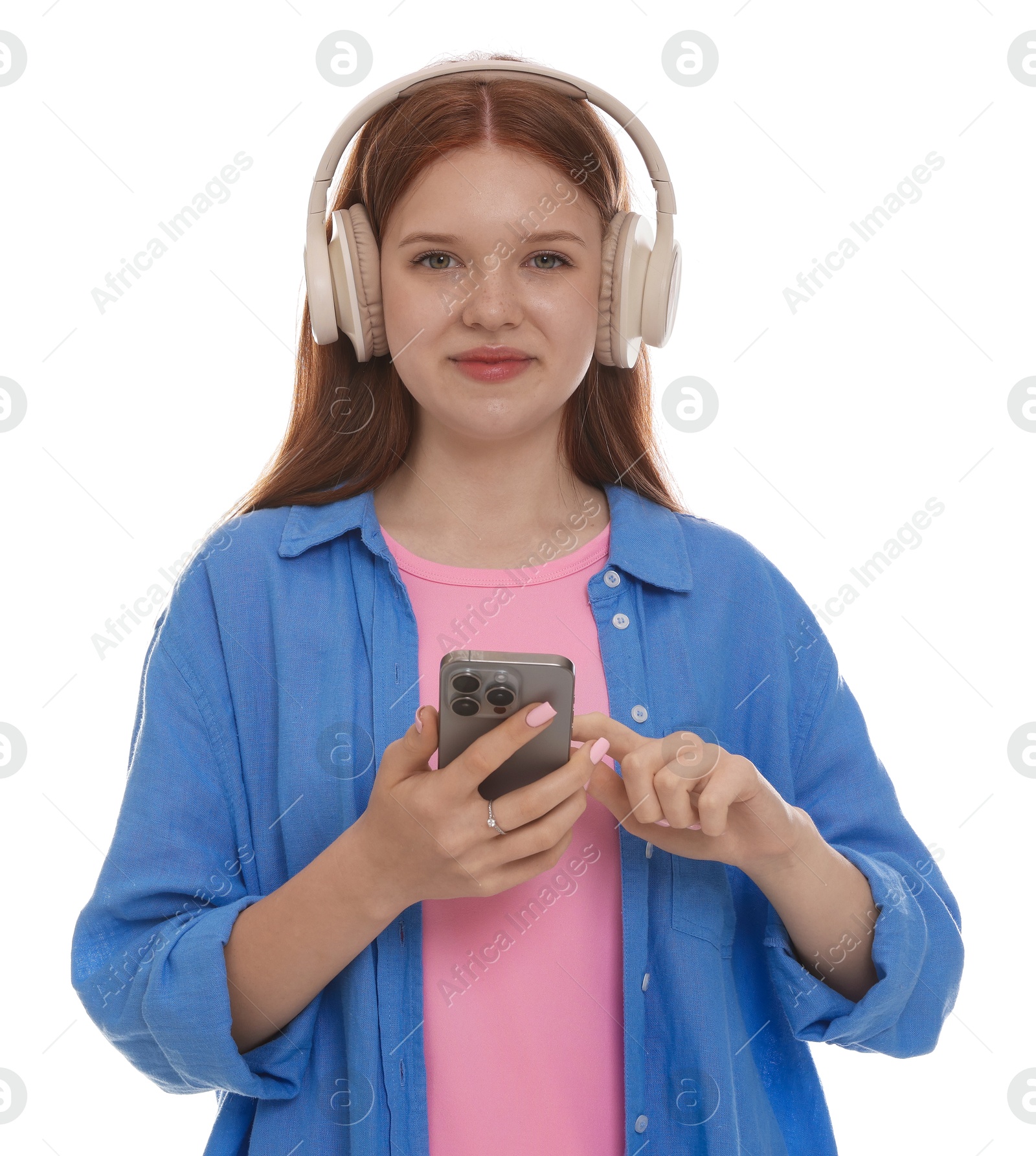 Beautiful teenage girl in headphones using smartphone on white background Photo of Beautiful teenage girl in headphones using smartphone on white background