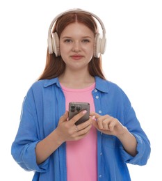 Photo of Beautiful teenage girl in headphones using smartphone on white background