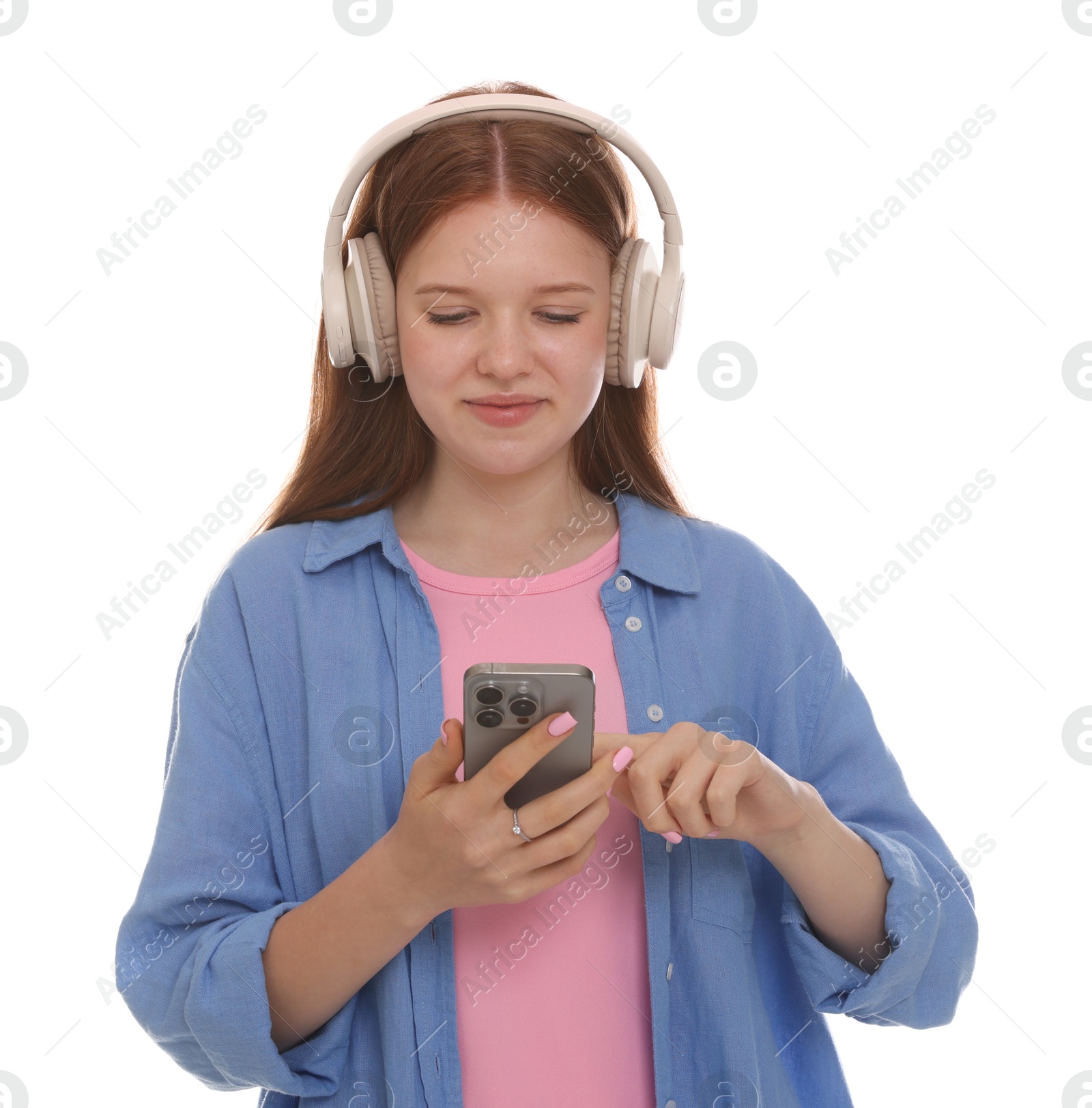 Beautiful teenage girl in headphones using smartphone on white background Photo of Beautiful teenage girl in headphones using smartphone on white background