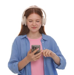 Photo of Beautiful teenage girl in headphones using smartphone on white background