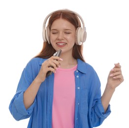 Photo of Happy teenage girl in headphones with smartphone singing on white background