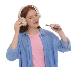 Photo of Happy teenage girl in headphones with smartphone singing on white background