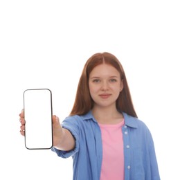 Photo of Beautiful teenage girl showing smartphone with blank screen on white background, selective focus. Mockup for design