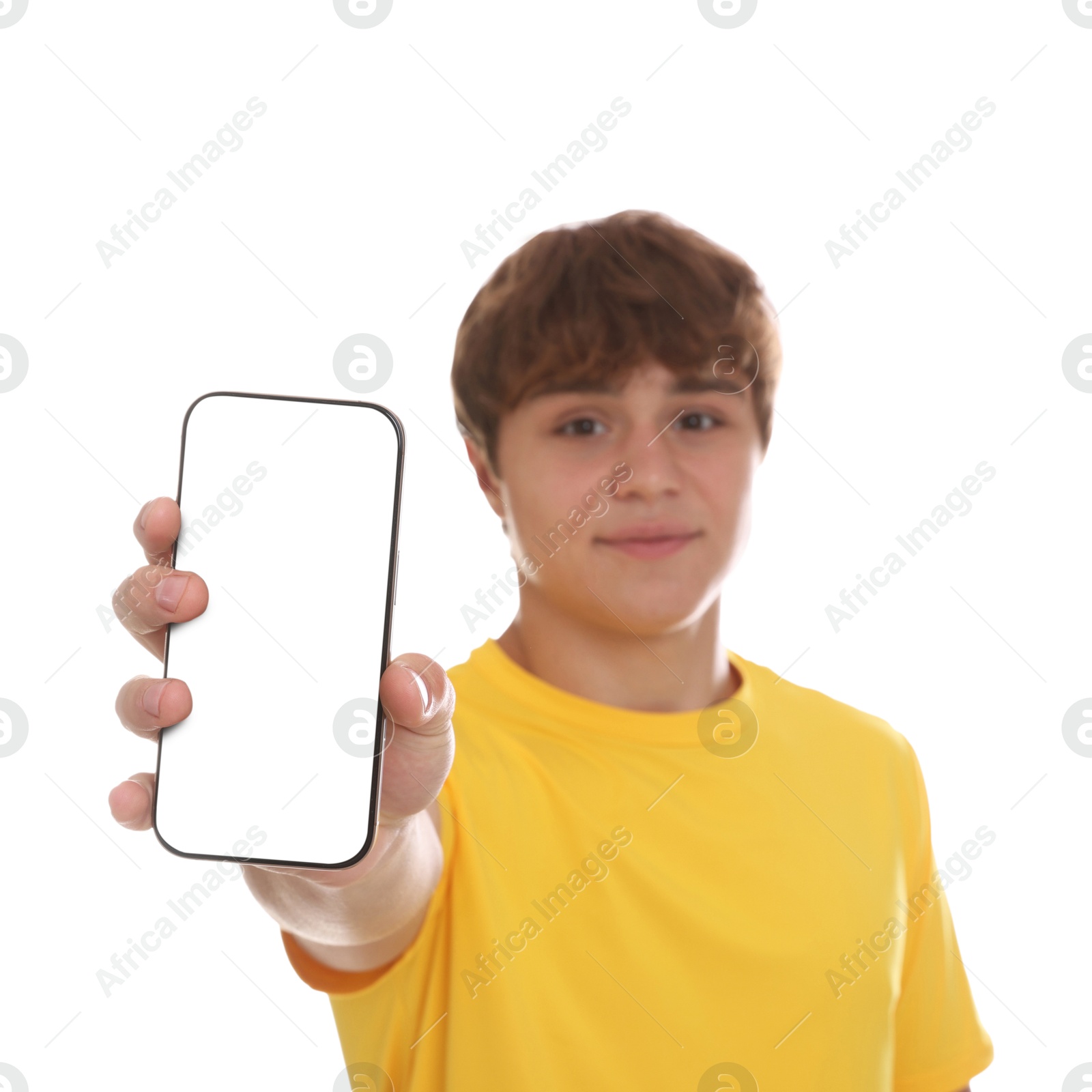 Photo of Teenage boy showing smartphone with blank screen on white background, selective focus. Mockup for design