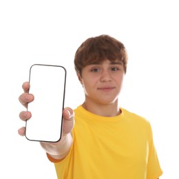 Photo of Teenage boy showing smartphone with blank screen on white background, selective focus. Mockup for design