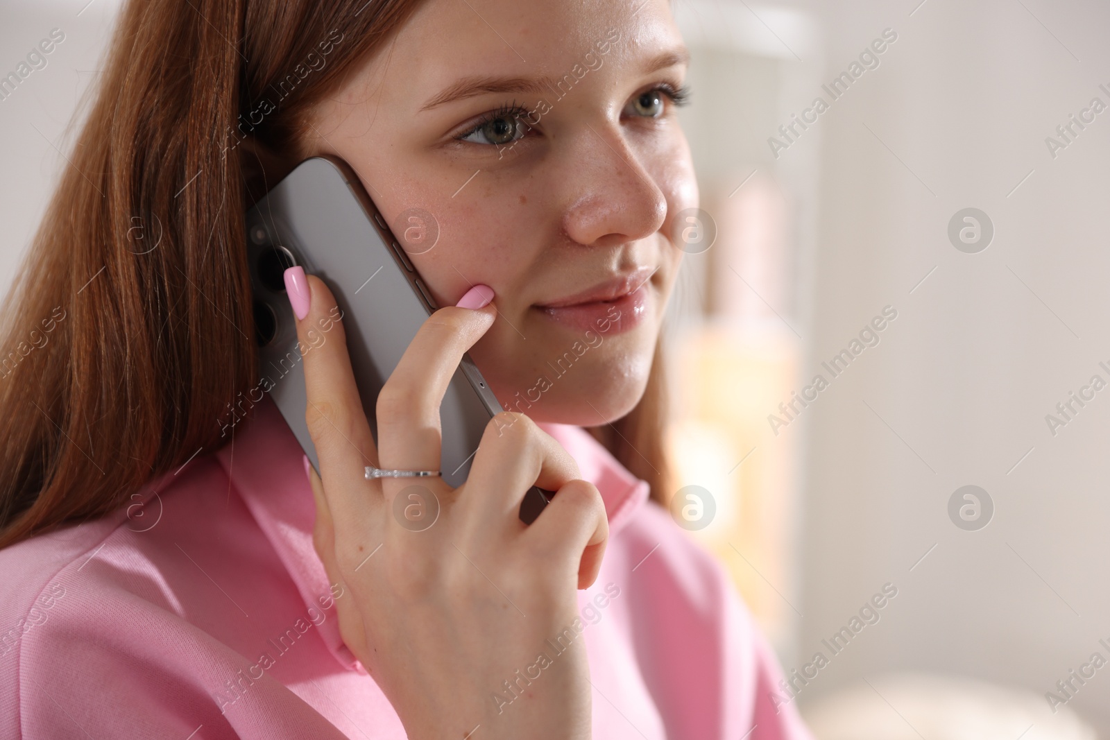 Teenage girl talking by smartphone at home Photo of Teenage girl talking by smartphone at home