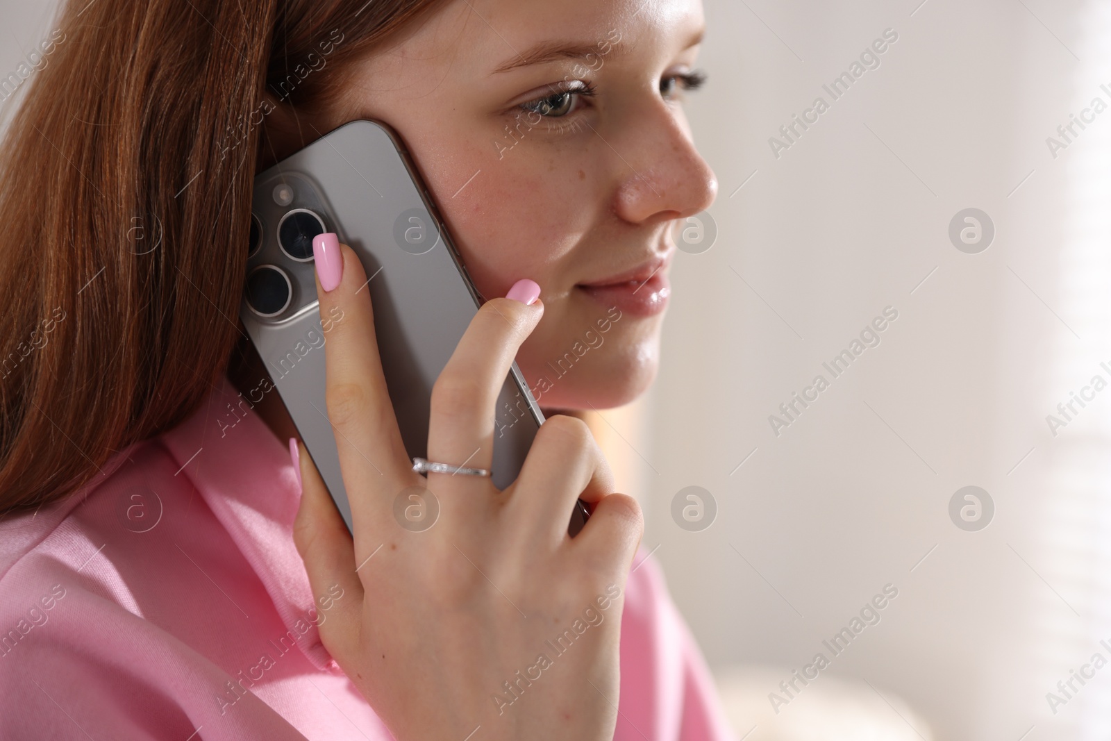 Teenage girl talking by smartphone at home Photo of Teenage girl talking by smartphone at home