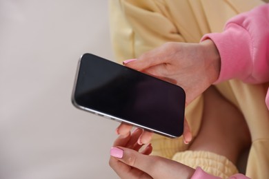 Photo of Teenage girl with smartphone at home, closeup