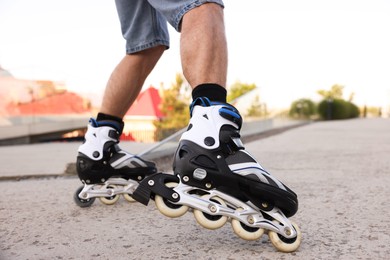 Photo of Man roller skating on city street, closeup