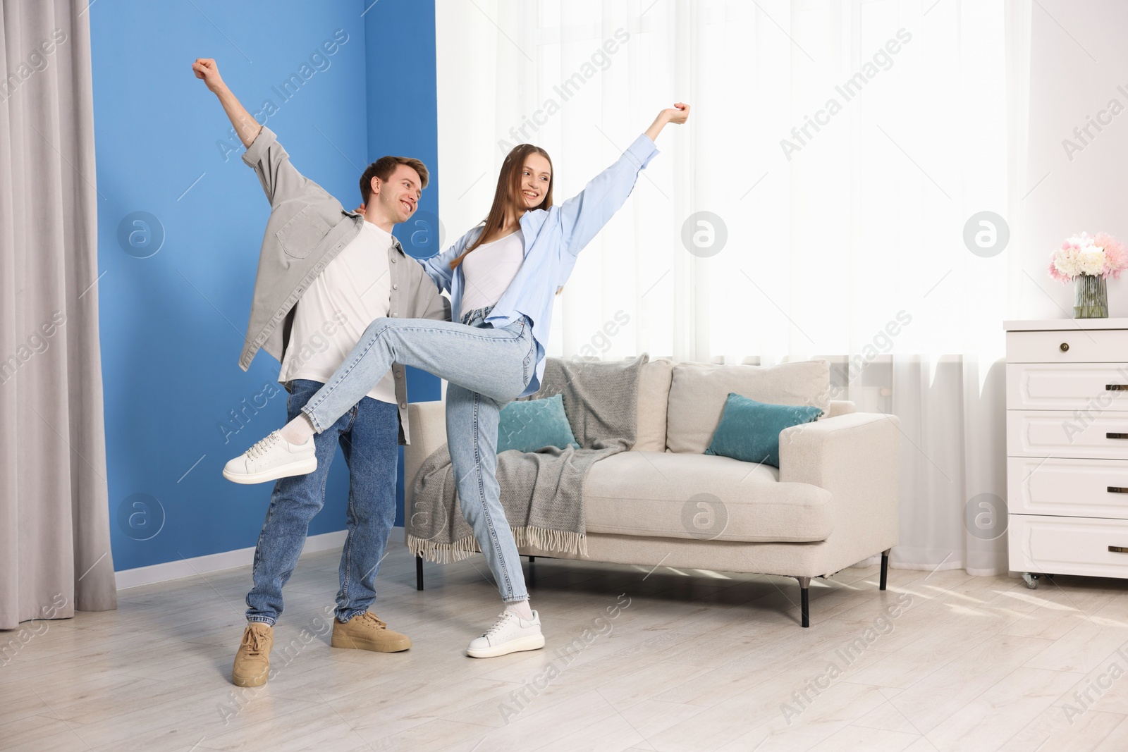 Happy young couple dancing together at home Photo of Happy young couple dancing together at home