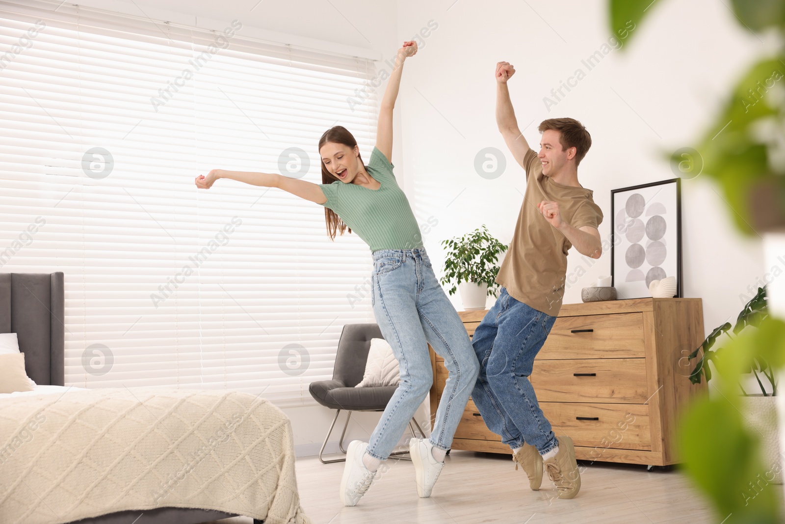 Happy young couple dancing together at home Photo of Happy young couple dancing together at home