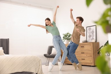 Photo of Happy young couple dancing together at home