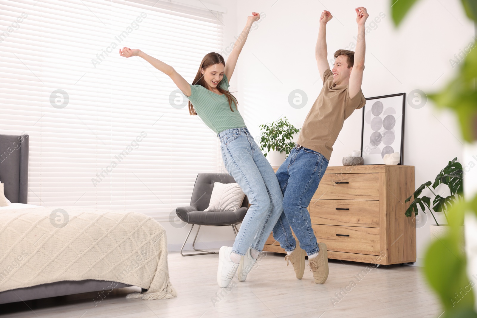 Happy young couple dancing together at home Photo of Happy young couple dancing together at home