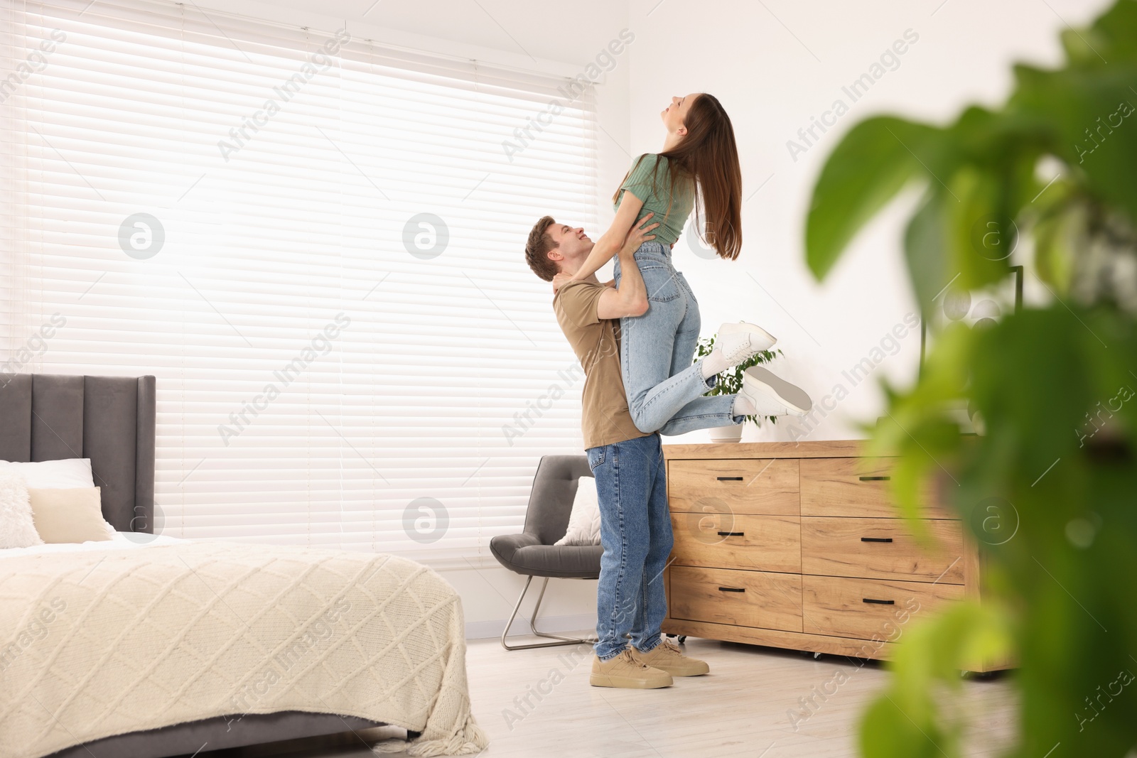Happy young couple dancing together in bedroom Photo of Happy young couple dancing together in bedroom