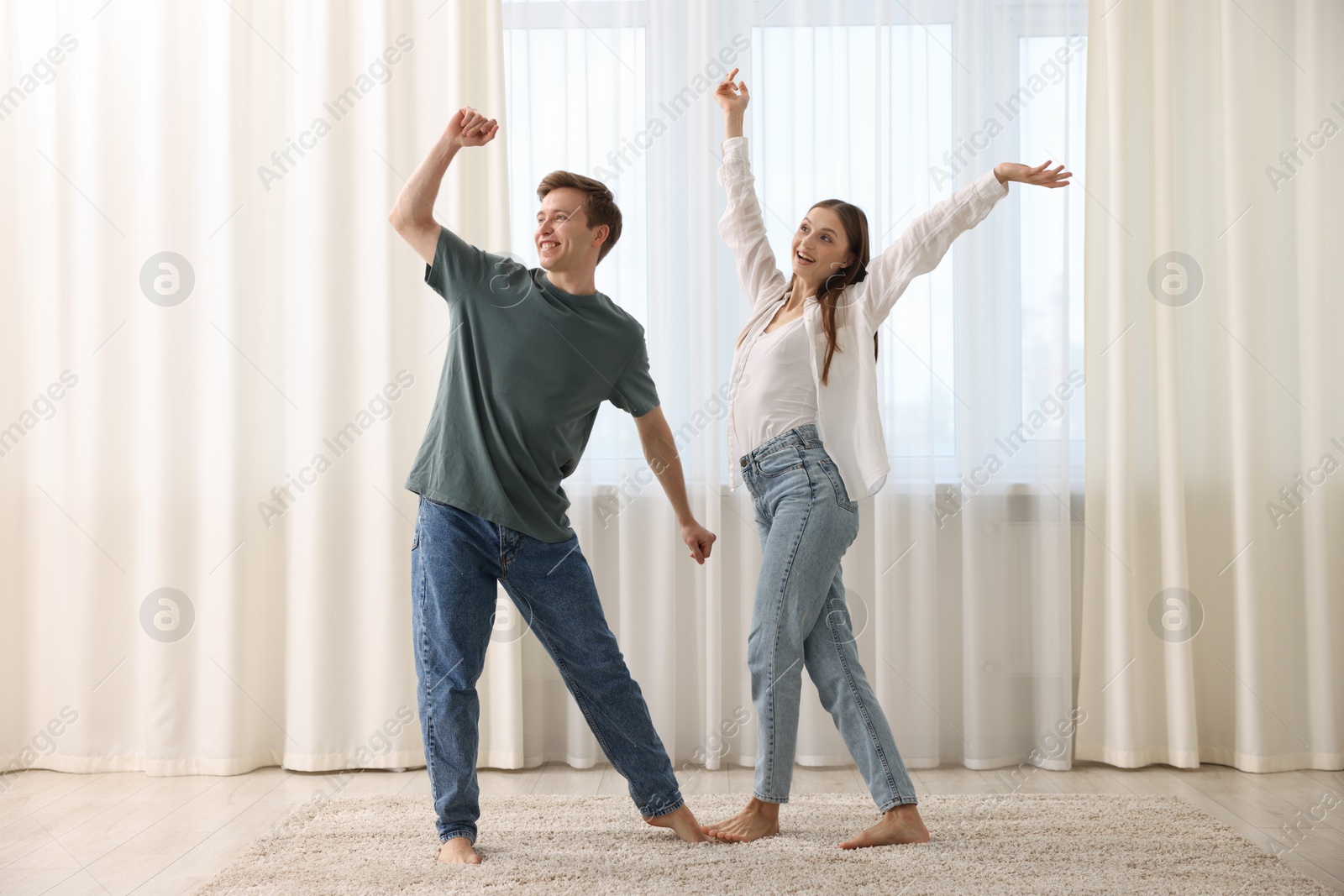 Happy young couple dancing together at home Photo of Happy young couple dancing together at home