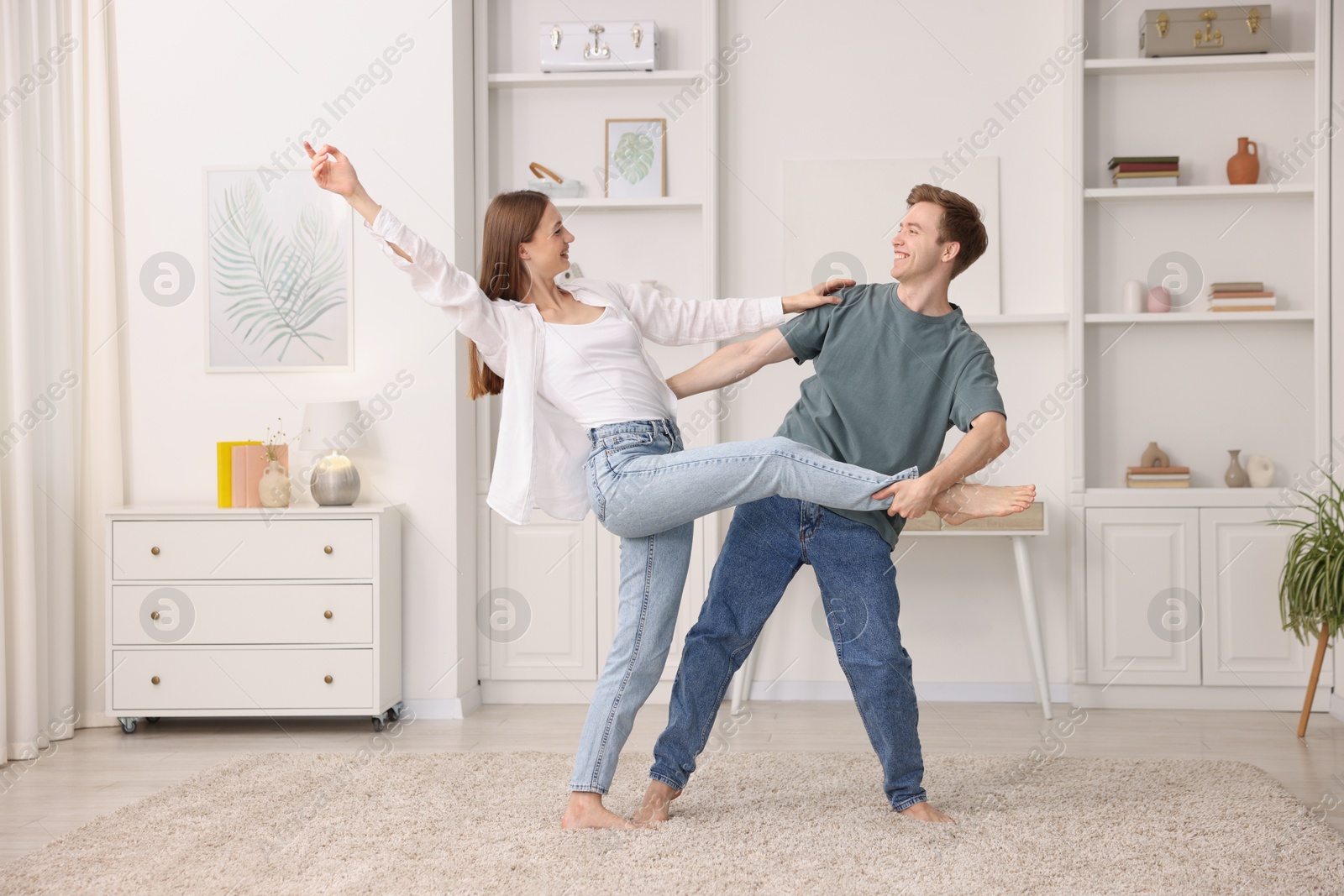 Happy young couple dancing together at home Photo of Happy young couple dancing together at home