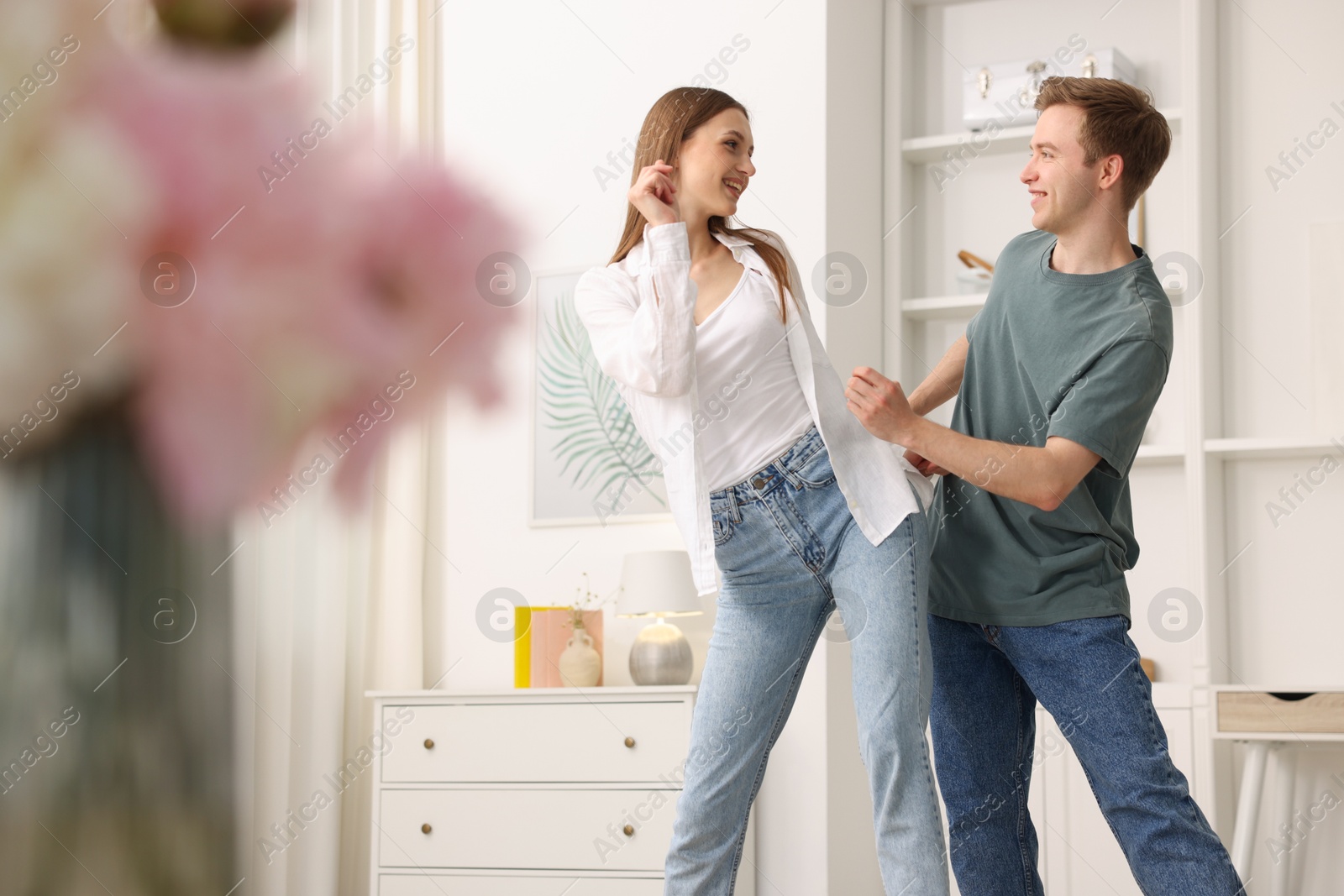 Happy young couple dancing together at home Photo of Happy young couple dancing together at home