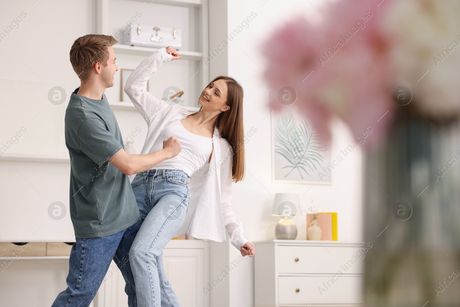 Happy young couple dancing together at home Photo of Happy young couple dancing together at home