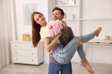 Photo of Happy young couple dancing together at home