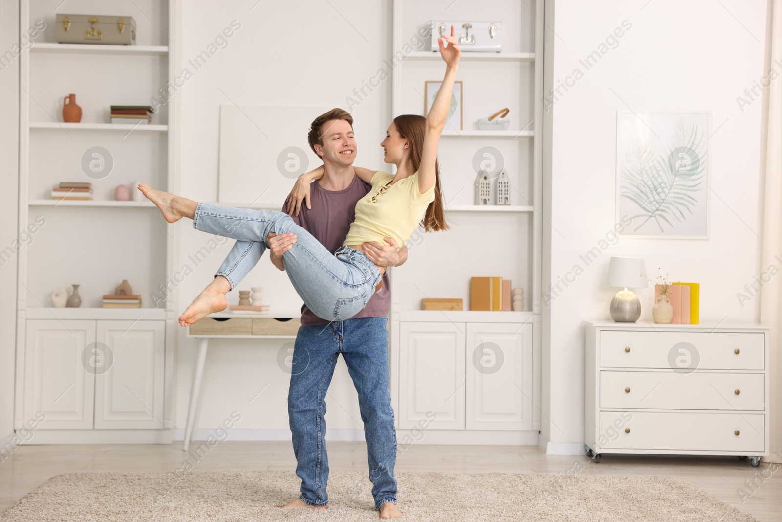 Happy young couple dancing together at home Photo of Happy young couple dancing together at home