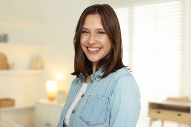 Photo of Portrait of smiling teenage girl at home
