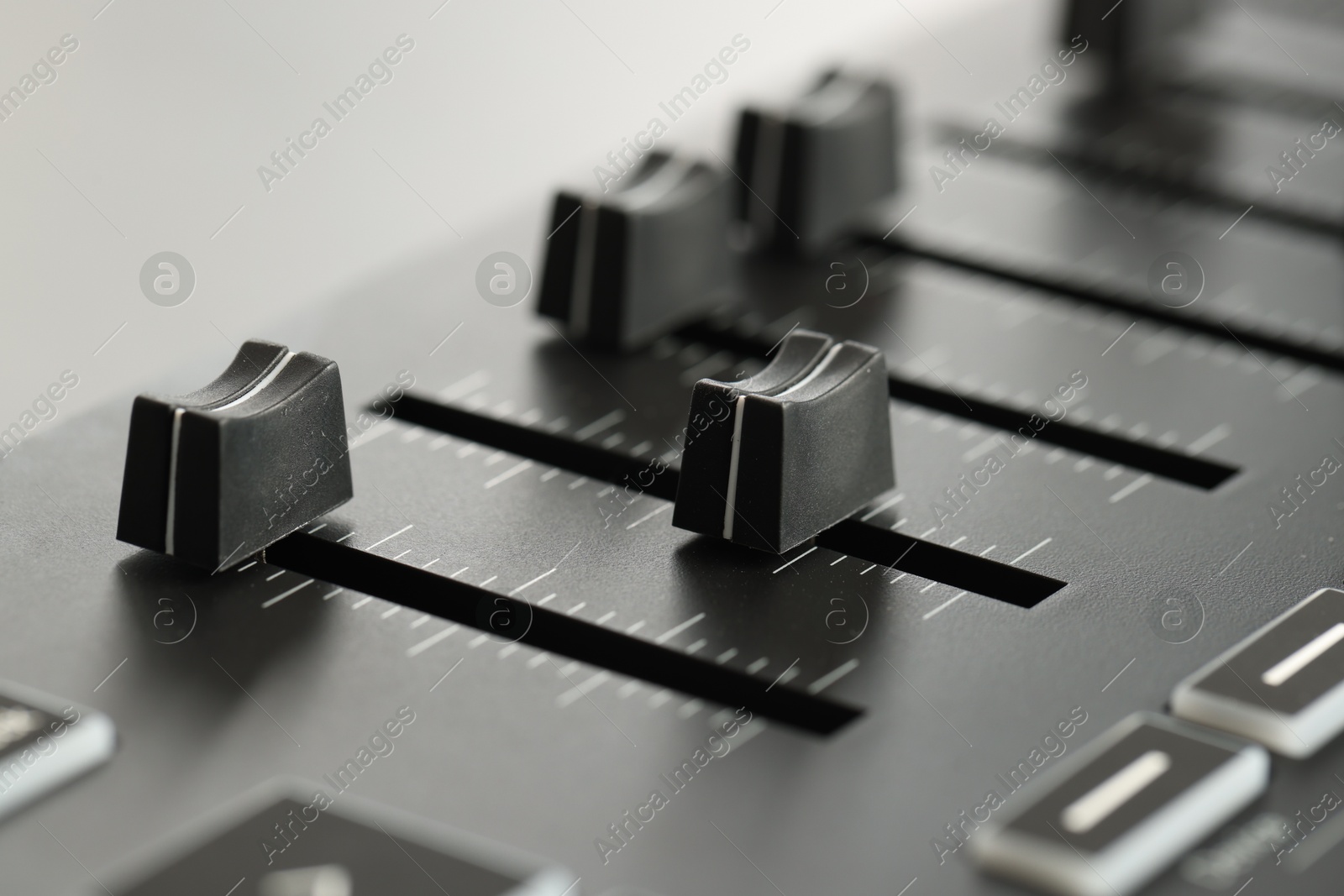 MIDI keyboard with faders on light background, closeup Photo of MIDI keyboard with faders on light background, closeup