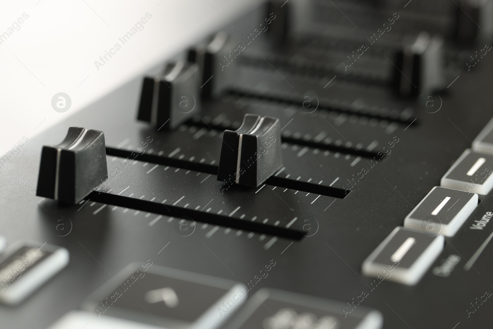 MIDI keyboard with faders on light background, closeup Photo of MIDI keyboard with faders on light background, closeup