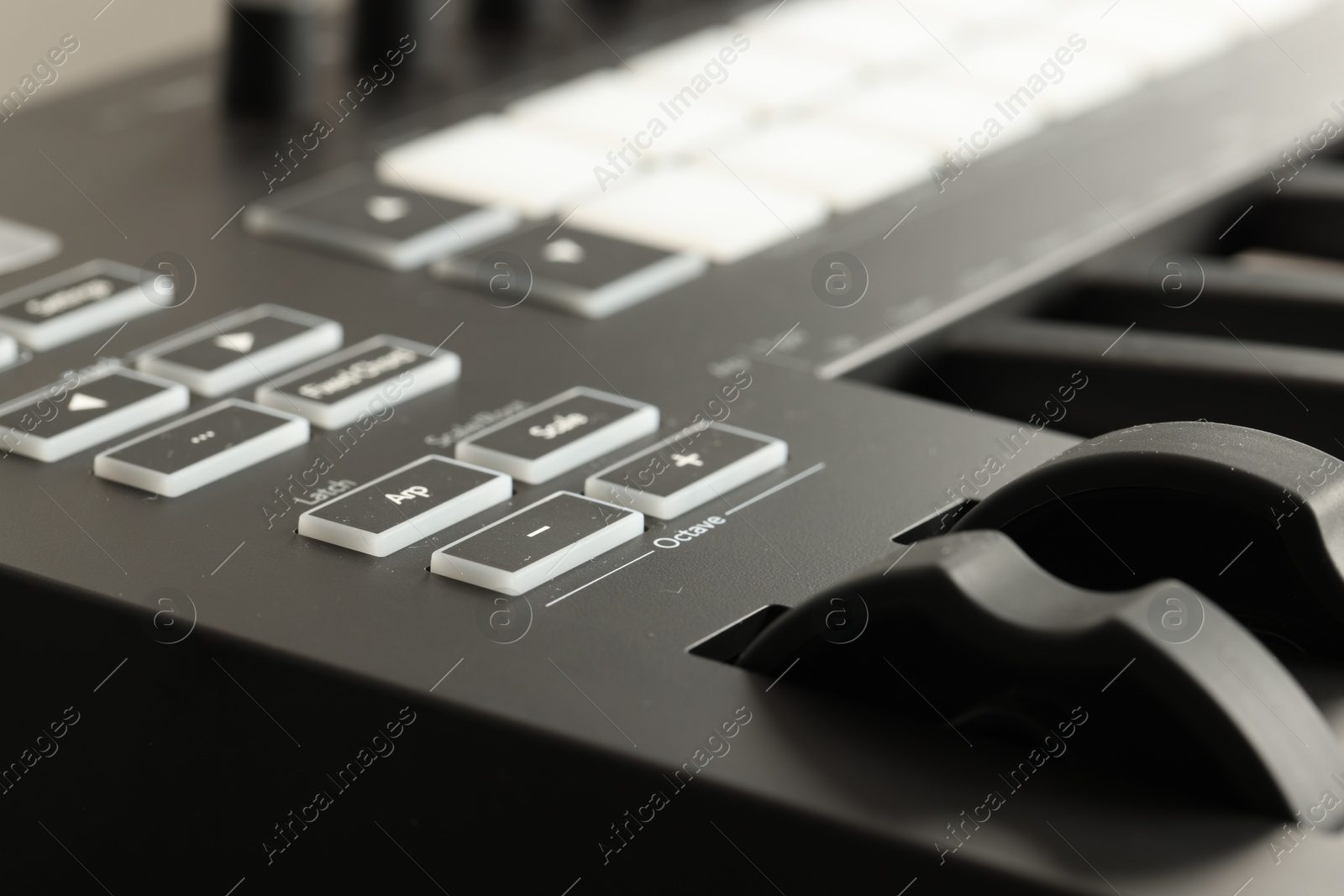 MIDI keyboard with buttons and faders, closeup Photo of MIDI keyboard with buttons and faders, closeup