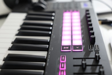 Photo of One portable MIDI keyboard on table, closeup
