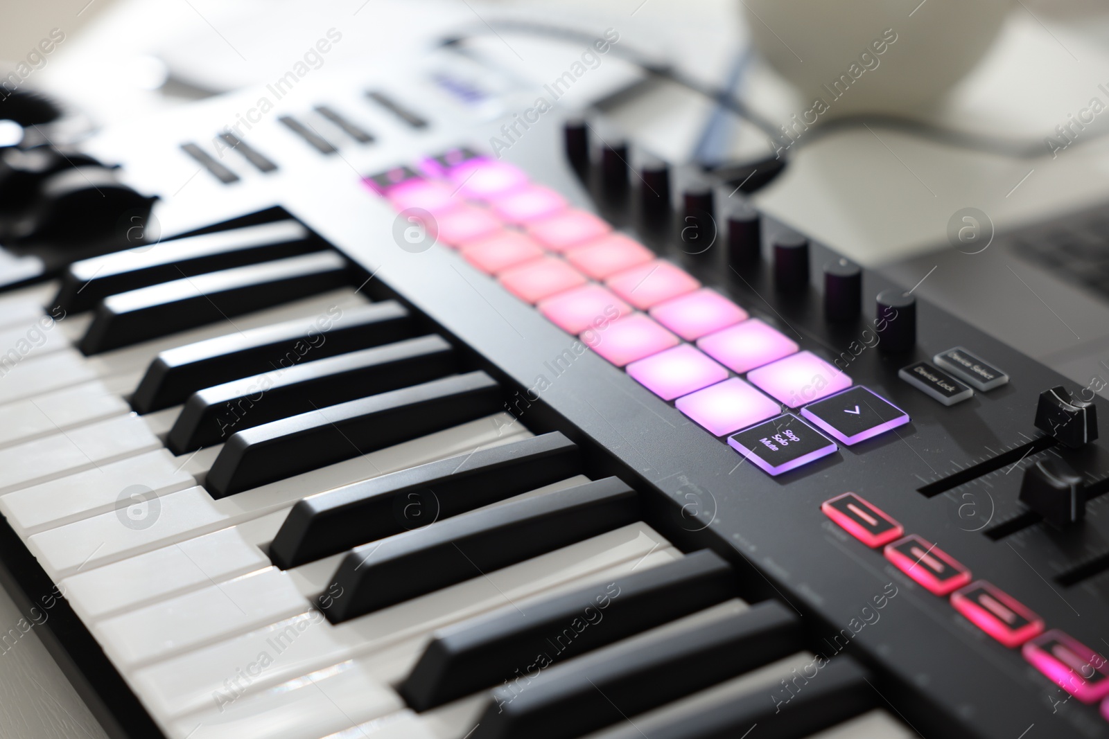 One portable MIDI keyboard on table, closeup Photo of One portable MIDI keyboard on table, closeup