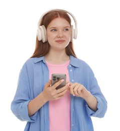 Photo of Beautiful teenage girl in headphones using smartphone on white background