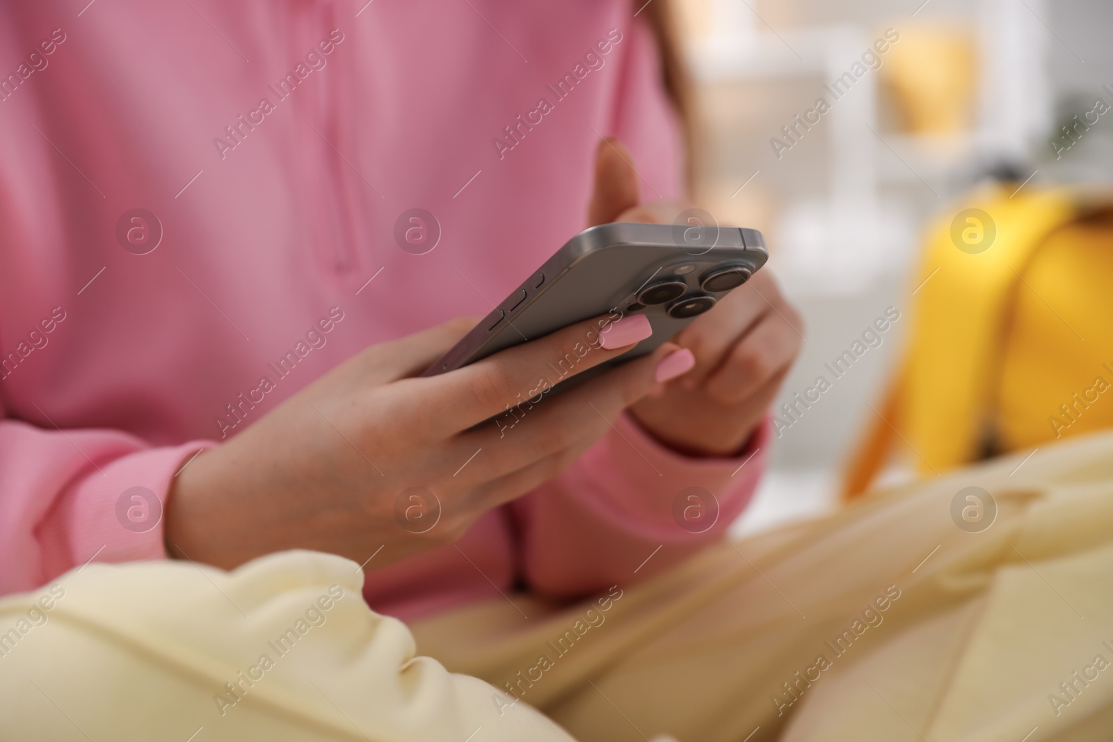 Teenage girl using smartphone at home, closeup Photo of Teenage girl using smartphone at home, closeup