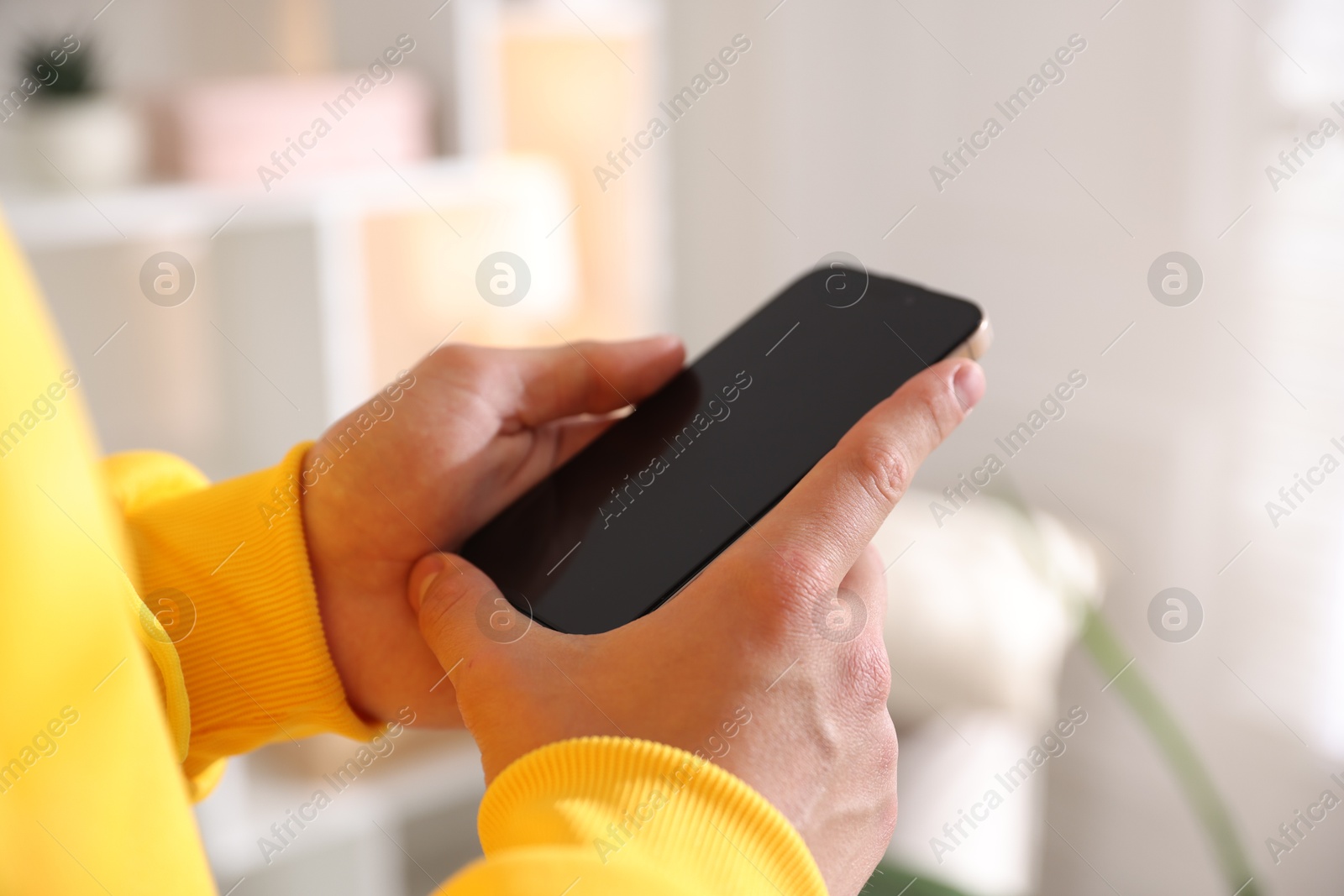 Teenage boy using smartphone at home, closeup Photo of Teenage boy using smartphone at home, closeup