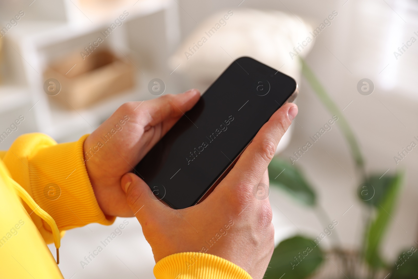 Teenage boy using smartphone at home, closeup Photo of Teenage boy using smartphone at home, closeup