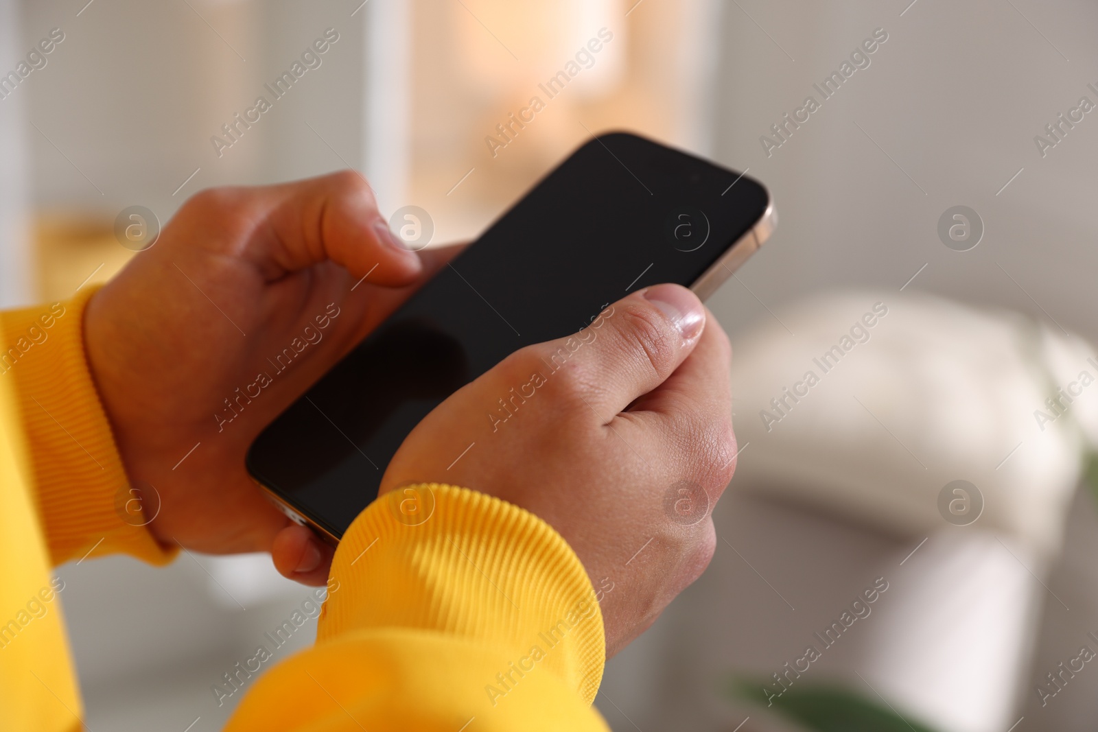Teenage boy using smartphone at home, closeup Photo of Teenage boy using smartphone at home, closeup