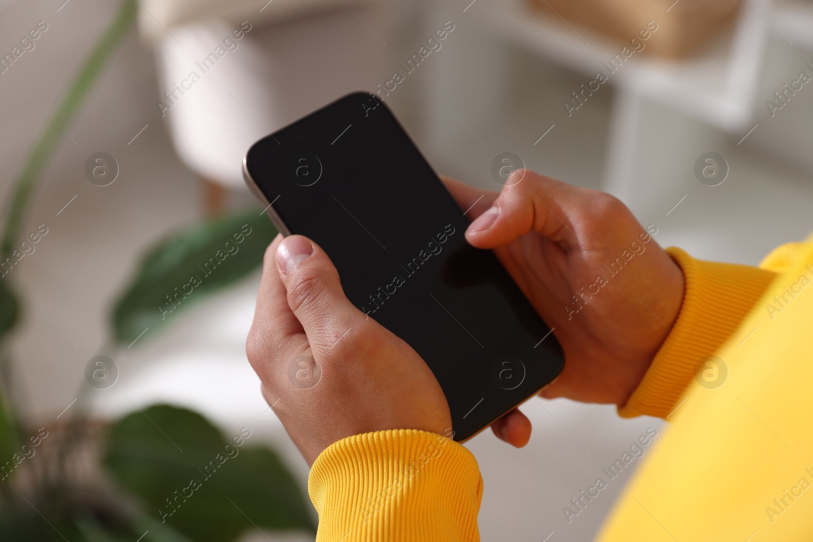 Teenage boy using smartphone at home, closeup Photo of Teenage boy using smartphone at home, closeup