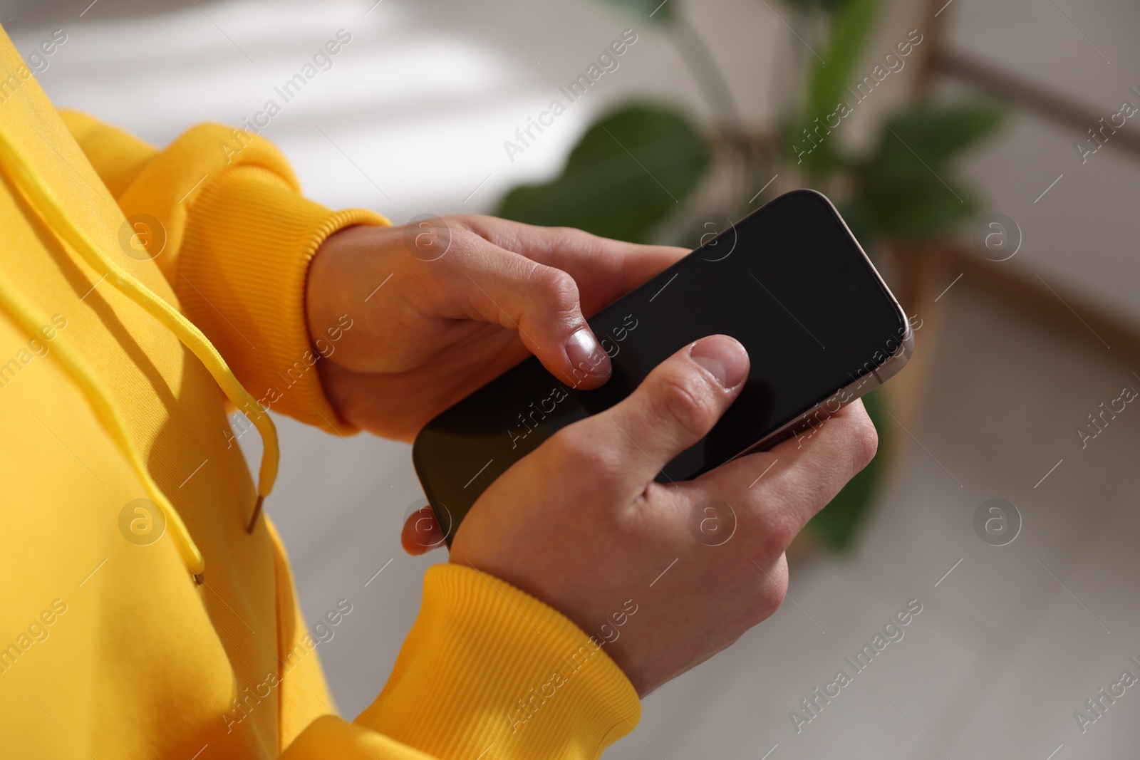 Teenage boy using smartphone at home, closeup Photo of Teenage boy using smartphone at home, closeup