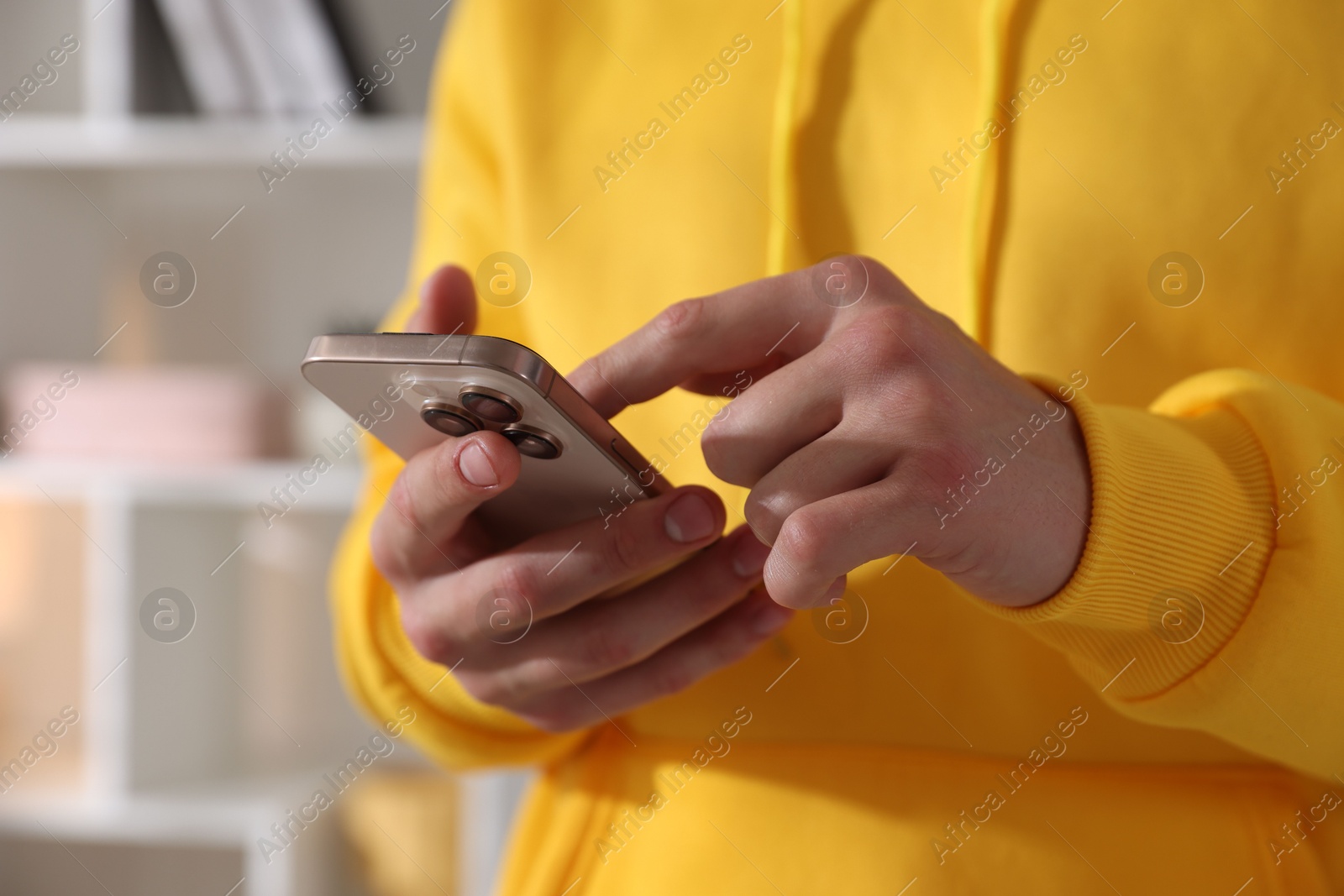 Teenage boy using smartphone at home, closeup Photo of Teenage boy using smartphone at home, closeup