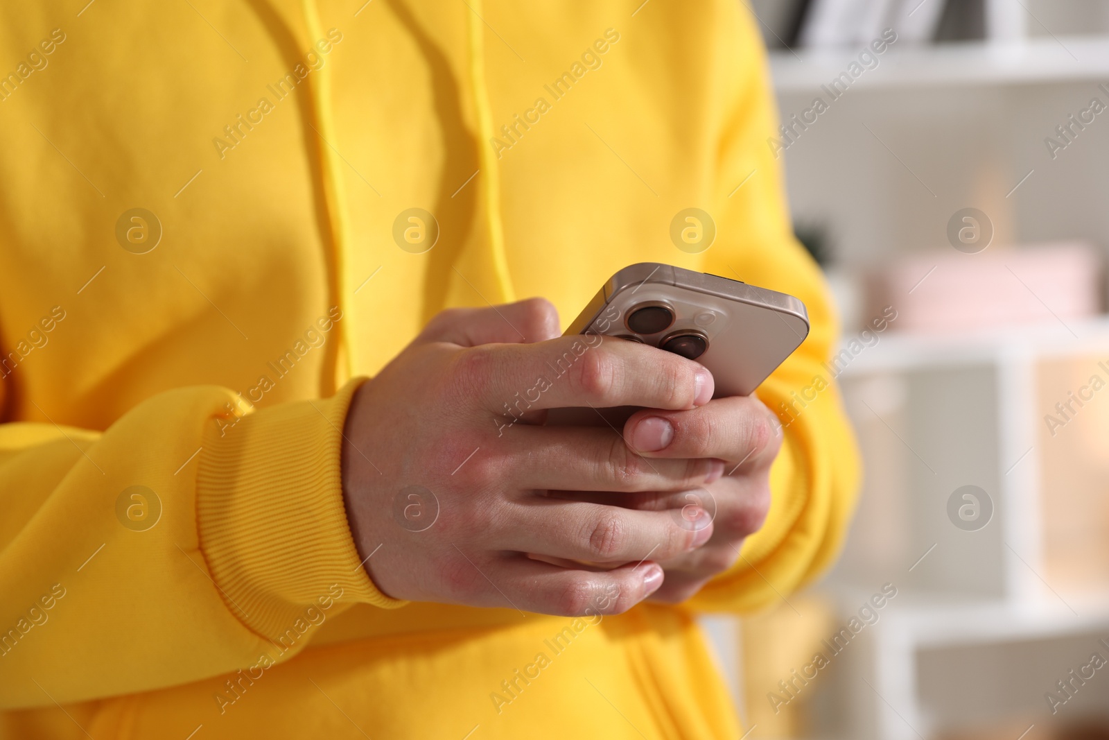 Teenage boy using smartphone at home, closeup Photo of Teenage boy using smartphone at home, closeup