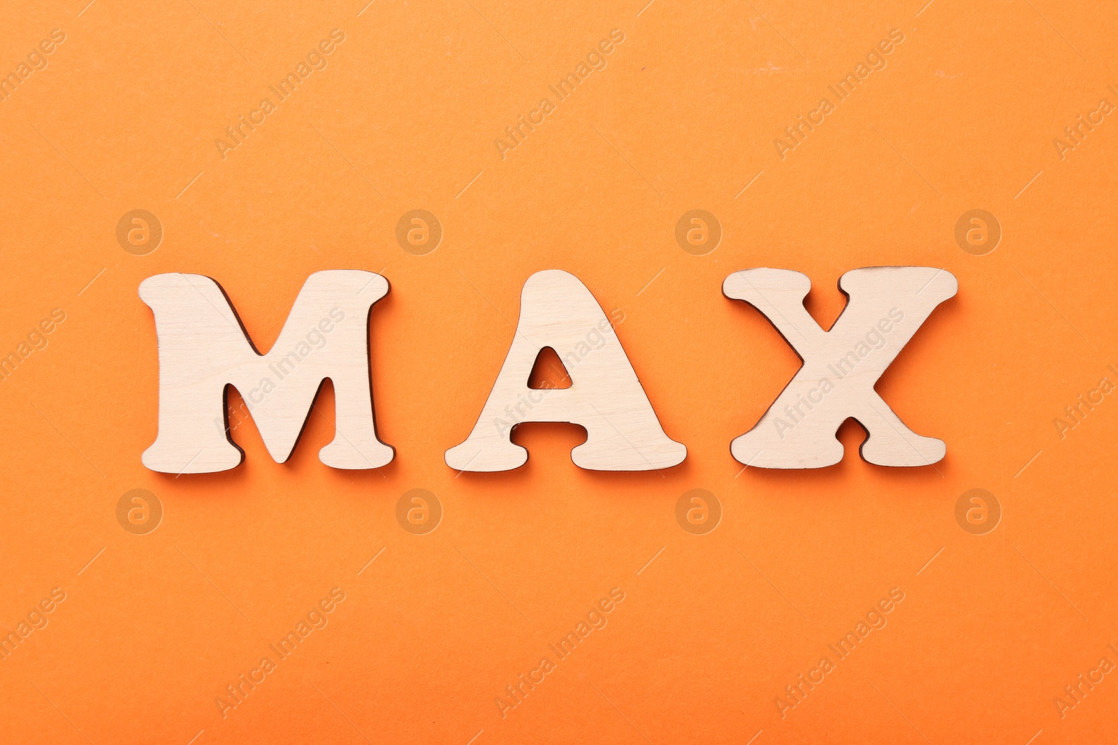 Word Max made of wooden letters on orange background, top view Photo of Word Max made of wooden letters on orange background, top view