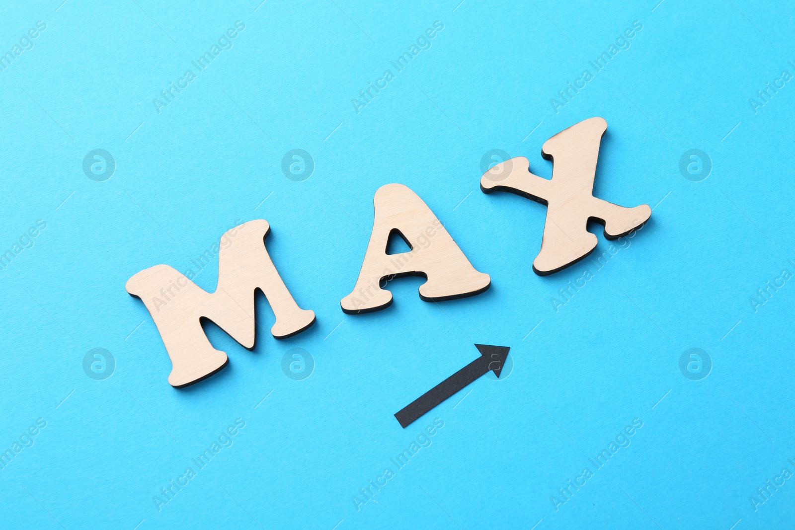 Word Max made of wooden letters and arrow on light blue background, flat lay Photo of Word Max made of wooden letters and arrow on light blue background, flat lay