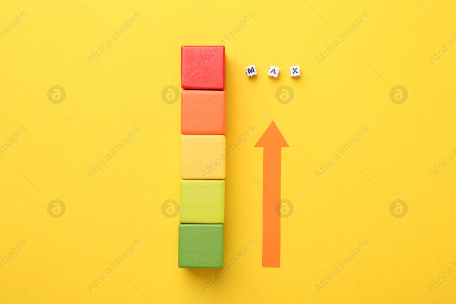 Colorful cubes and arrow pointing at word Max made of beads with letters on yellow background, flat lay Photo of Colorful cubes and arrow pointing at word Max made of beads with letters on yellow background, flat lay