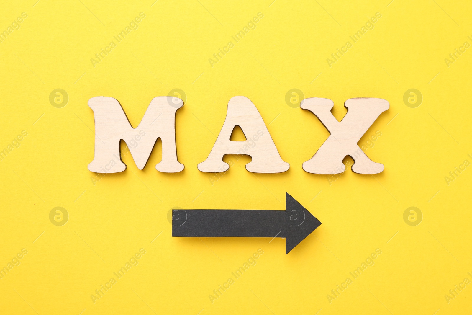 Word Max made of wooden letters and arrow on yellow background, flat lay Photo of Word Max made of wooden letters and arrow on yellow background, flat lay