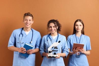 Photo of Group of medical students with microscope on brown background