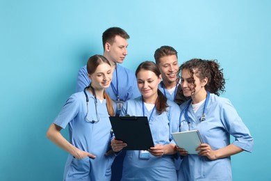 Photo of Group of medical students on light blue background