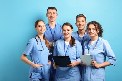 Photo of Group of medical students on light blue background