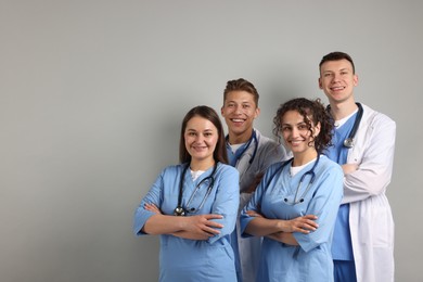Photo of Group of medical students on light grey background. Space for text
